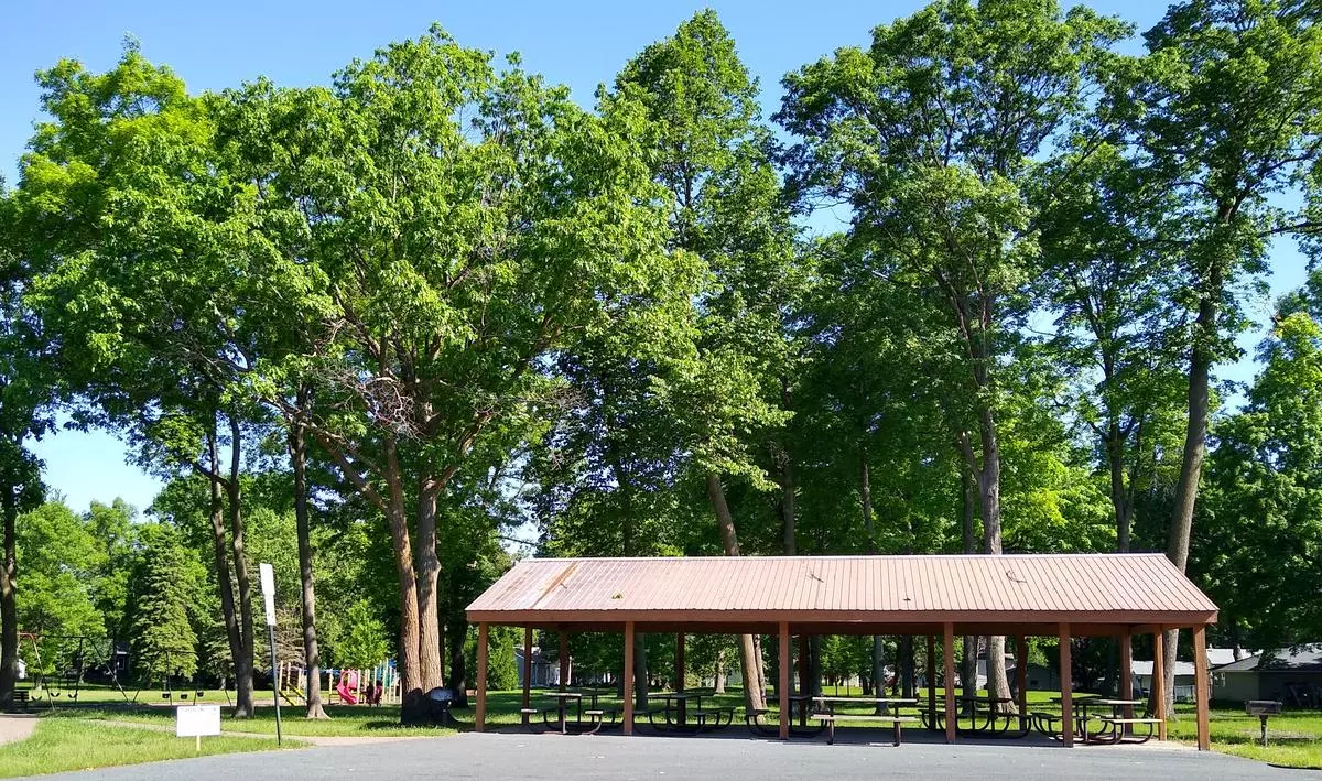 picnic shelter in front of leafy trees