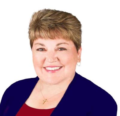 Julie Maas-Kusske sitting in front of a blank background