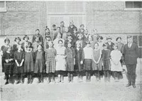 group of students and teachers outside their school