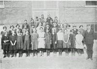 group of students and teachers outside their school