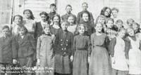 group of teen boys and girls outside their school